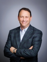 Headshot of John Couris, President and CEO of the Florida Health Sciences Center (FHSC), with a Gray Studio Backdrop