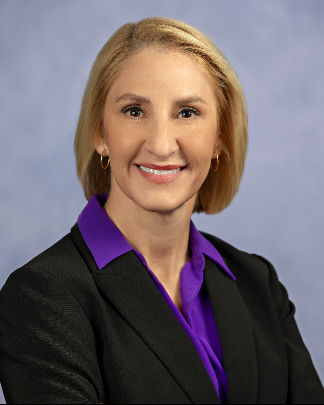 stacey brandt headshot with gray studio backdrop